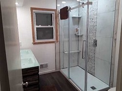 Tiled walls with large rain fall shower head and wand