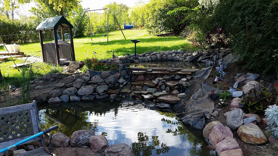 I Believe this was my final version. If you were not aware of the horse walking around that would be my big teddy bear Boomer. where the pond ends at the bottom of the photo that is actually a ramp to walk down in because its almost 2' deep. Around remodel 3 the ramp was put in because i was sick of boomer jumping out over the sides to chase a squrrle and knocking my rock out of place. So he got a ramp and was restricted to using it. He spent a lot of time in that pond in the summer